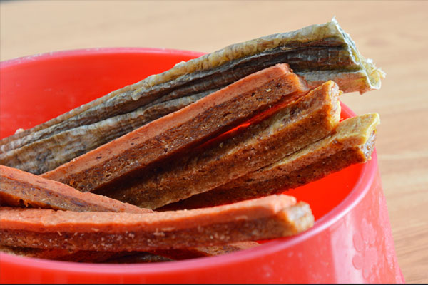 pet food chicken soft jerky on red bowl